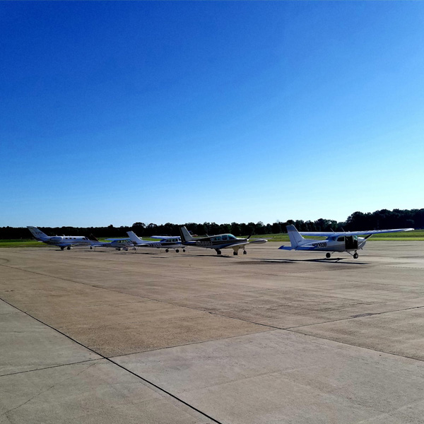 Small general aviation aircraft lined up on the runway at Michigan City Municipal Airport